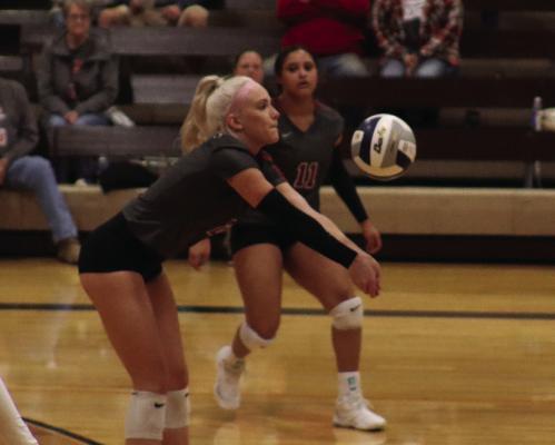 Hi-Line’s Carley Thomspon digs a ball and passes to a teammate.