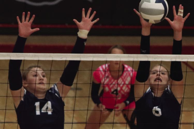 Southwest’s Atleigh Nelms and Kyra Nelms rise to block an attack.
